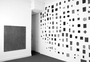 Howard Smith. Exhibition view at Björn Ressle Gallery. From left: "Cassandra." Oil on canvas. 60 x 58 in; "Universe (XV)." Variously sized oil on canvas.